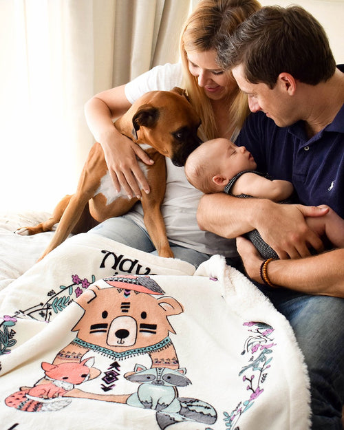 Dog kissing New family member on Lil Be Adventure Plush baby blanket