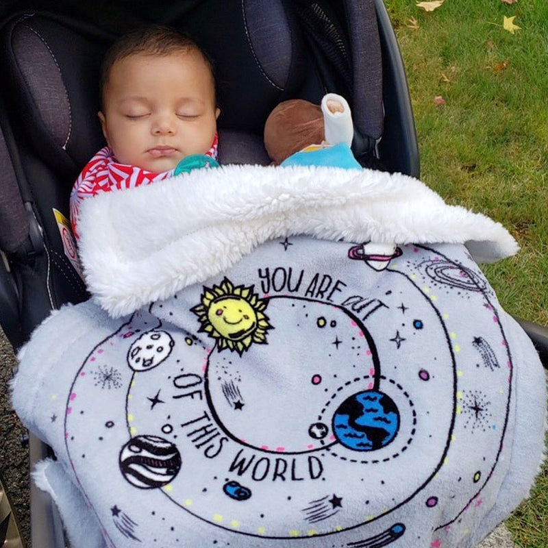 Baby in their stroller wrapped in Galaxy Security Blanket
