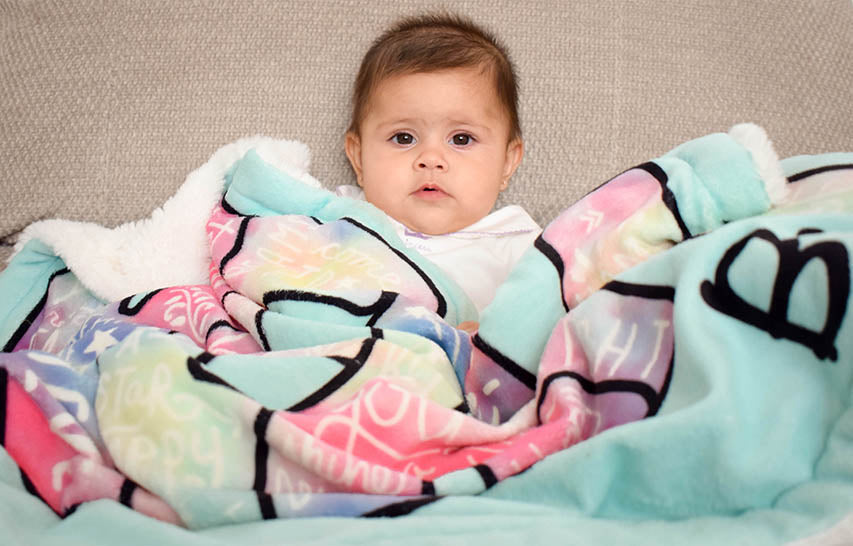 Baby Girl Covered in Dream Big Baby Blanket