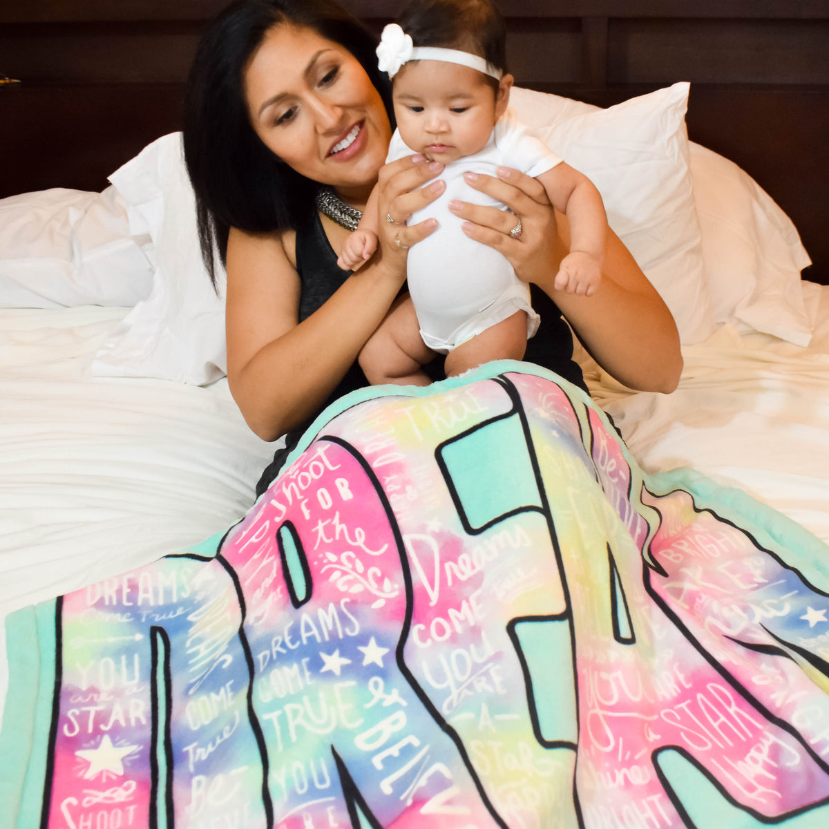 Mommy and Baby Girl Covered with Dream Big Plush Baby Blanket