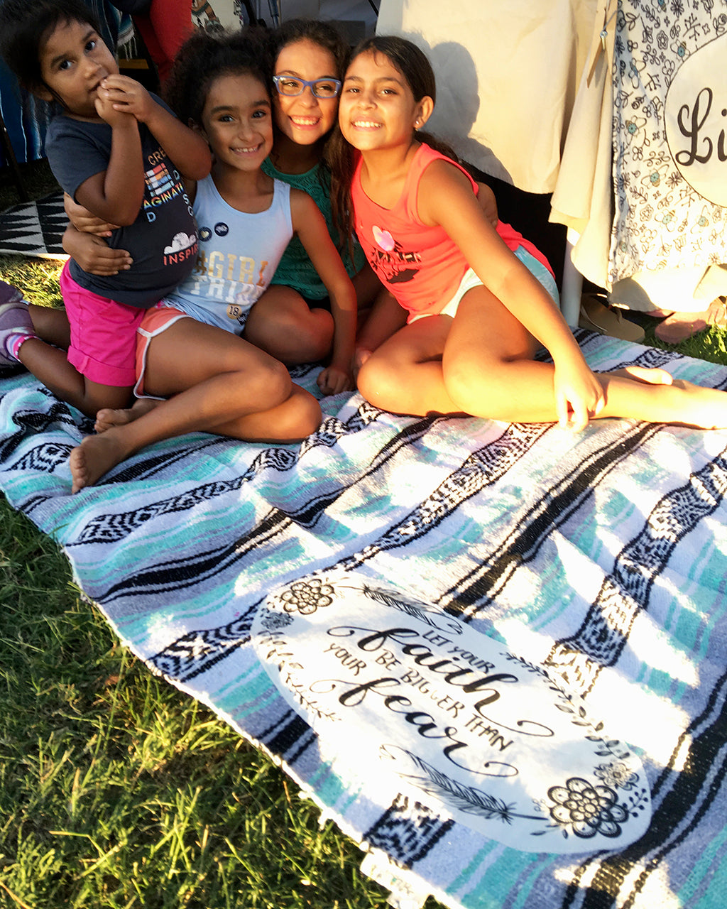4 girls smiling on mexican throw blanket
